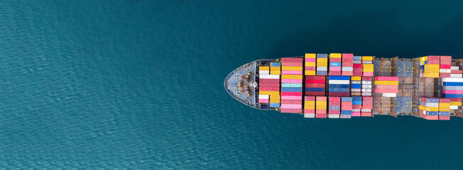 Aerial top view Cargo Ship carrying container and running for export goods from cargo yard port to other ocean concept freight shipping ship . - obrazy, fototapety, plakaty
