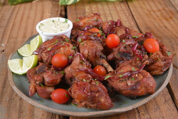 fried chicken with tomatoes and caramelized onions wings with herb sauce