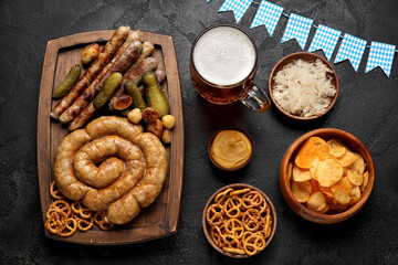 Mug of cold beer and different snacks on black background. Oktoberfest celebration