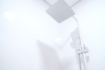 Modern rain shower faucet design. Bathroom. White tiles on the wall. Stylish bright bathroom