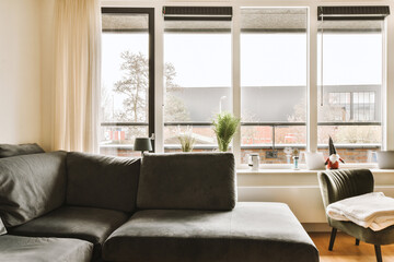 a living room with two couches and a coffee table in front of the window looking out onto the street