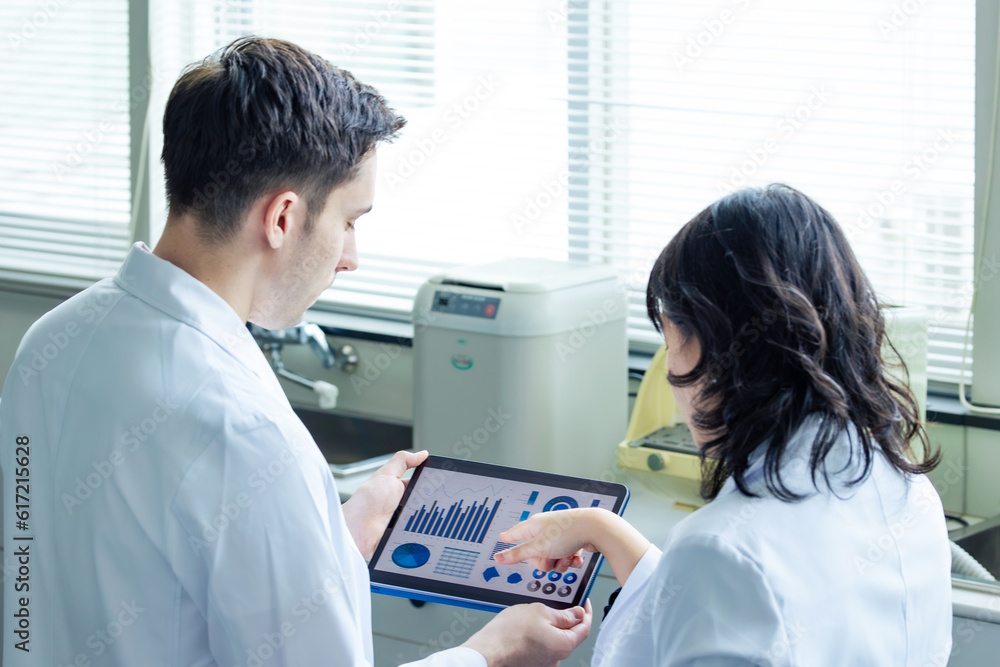 Poster Group of researchers looking at tablet data in the lab. Research and Development.