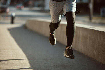 Young adult man jogging in the city
