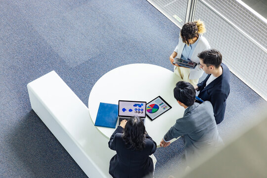 Multinational Business Group Talking In Lobby. Global Business. High Angle View.