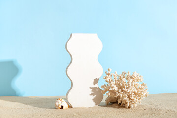 Obraz na płótnie Canvas Decorative plaster podium with coral and seashell on sand against blue background