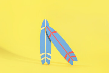 Mini surfboards on yellow background