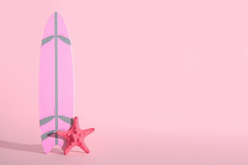 Mini surfboard with starfish on pink background