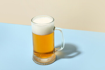 Mug of cold beer on color background