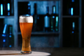 Glass of fresh beer on table in bar
