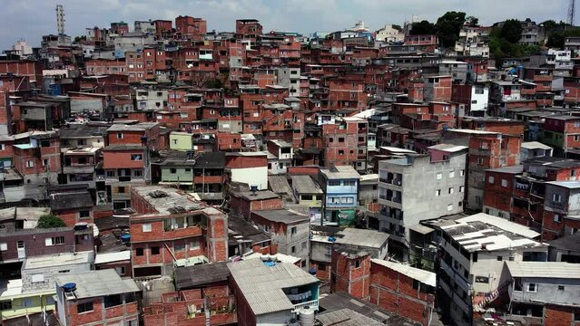 Drone shot over squatter homes, sunny day in Jaguare, Sao Paulo, Brazil, South America