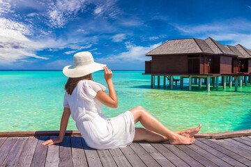 Woman sitting on the wooden pier