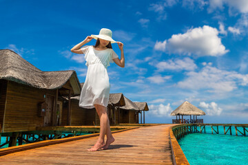 Woman standing on the wooden pier