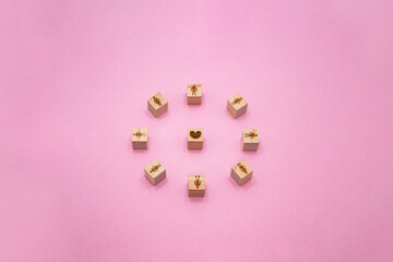 立体的な人の輪のウッドキューブがハートを囲んでいるピンクの背景