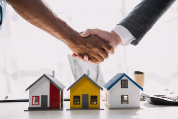 Real estate agent and customer signing contract to buy house, insurance or loan real estate.rent a house,get insurance or loan real estate or property.