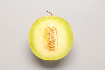 Half of sweet melon on grey background