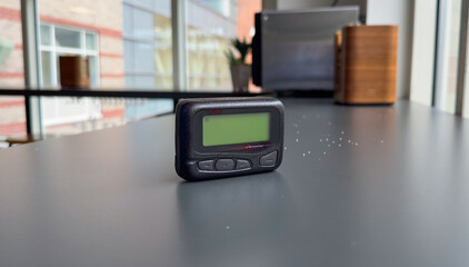 pager beeper device rests on a desk, representing the power of instant communication, connectivity, and the evolution of technology