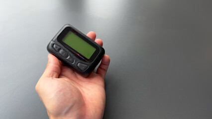 pager beeper device rests on a desk, representing the power of instant communication, connectivity, and the evolution of technology