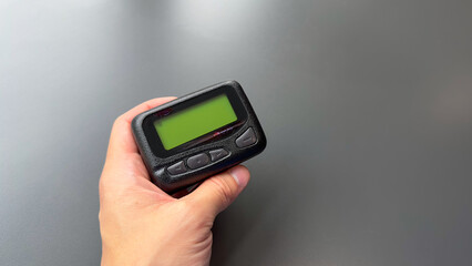 pager beeper device rests on a desk, representing the power of instant communication, connectivity, and the evolution of technology