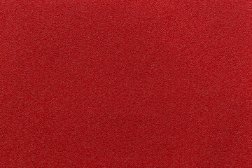 Red leather and a textured background.