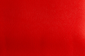 Red leather and a textured background.