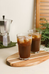 Pouring espresso from moka pot into a glass with tonic