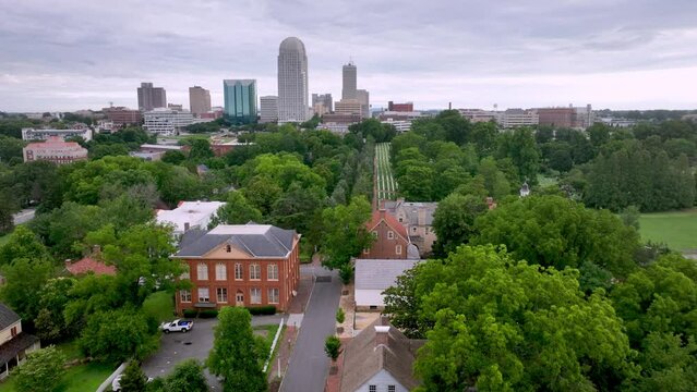 Aerial tilt up to reveal Winston Salem NC, North Carolina over Old Salem