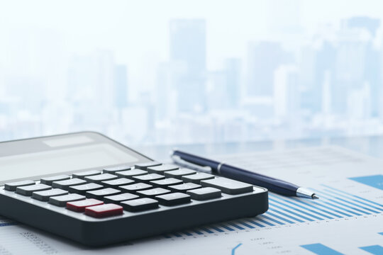 Business finance and accounting image. Business reports and calculator on desk. Cityscape background.