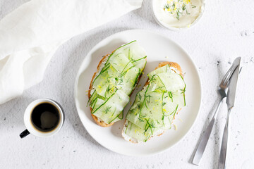Breakfast bread sandwiches with sliced cucumber and cream cheese.