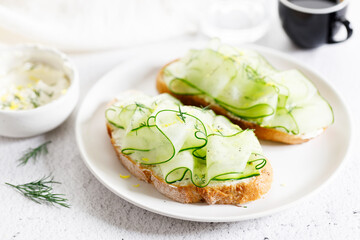 Breakfast bread sandwiches with sliced cucumber and cream cheese.