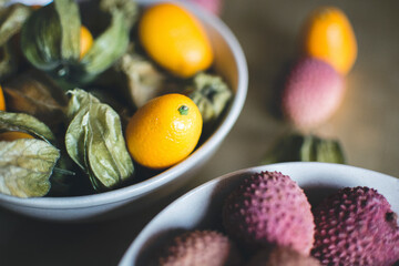Fototapeta na wymiar Cape gooseberries and lychees in a bowl
