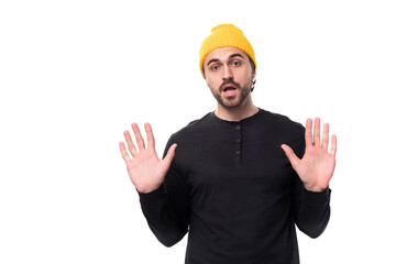 young brutal caucasian brunette man with a beard in a casual sweatshirt tired