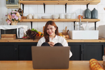 Portrait of a young cheerful asian woman at kitchen room with healthy raw food. Vegetarianism, wellbeing and healthy lifestyle concept