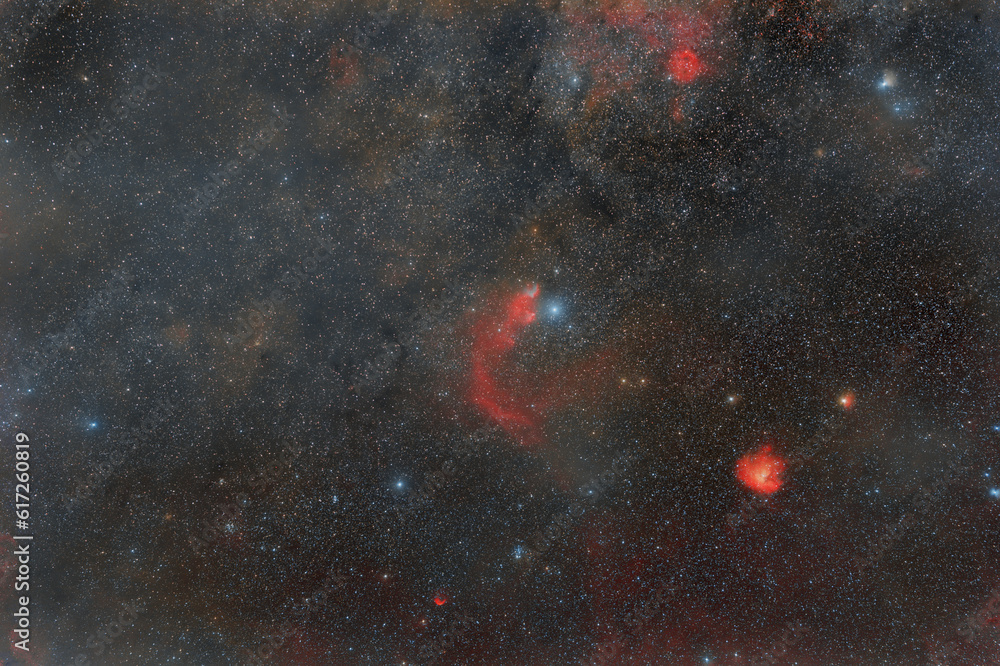 Wall mural photo of outer space. soft focus. lots of small stars all over the frame. foggy objects. red nebulae