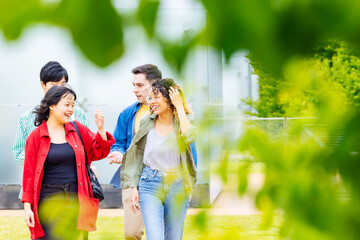 Multinational student group walking in college campus.
