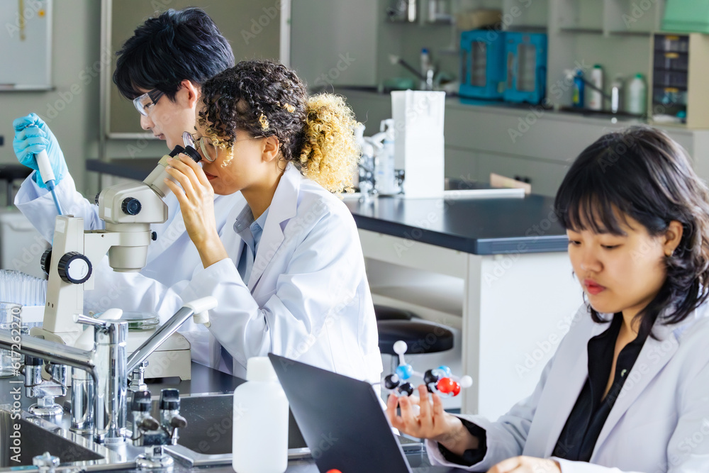 Poster multinational researcher group experimenting in the lab.