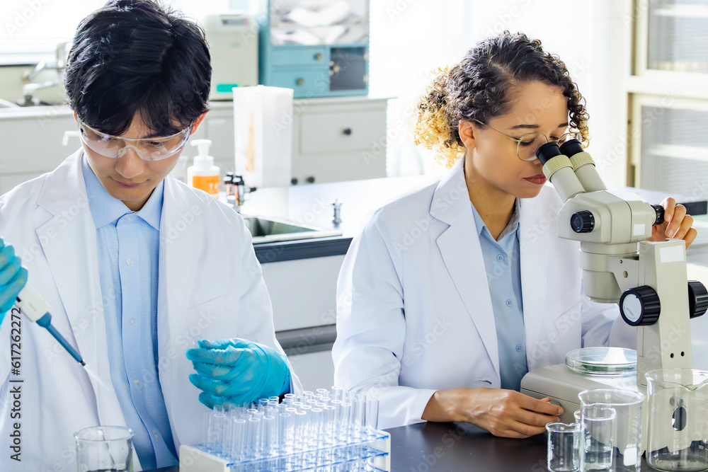 Poster multinational researcher group experimenting in the lab.