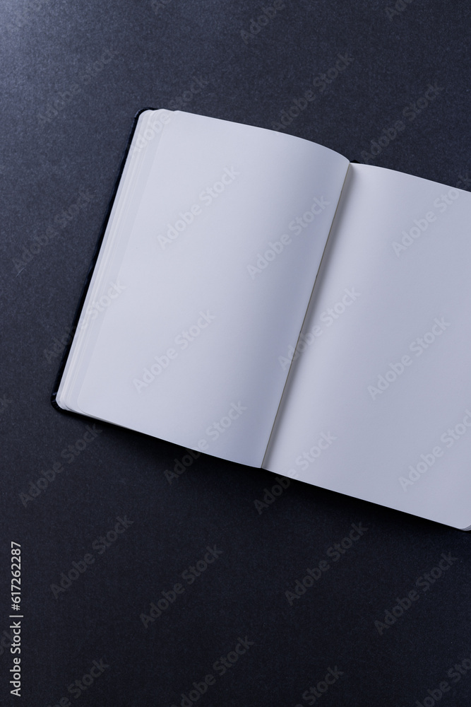 Poster close up of open book with copy space on black background