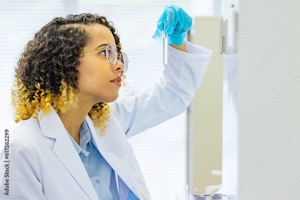 Aufkleber female scientist looking at a test tube. research and development.