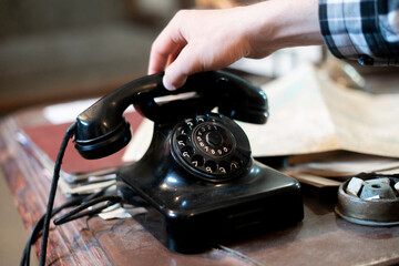 person making a phone call using an old vintage rotary telephone