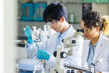 Multinational researcher group experimenting in the lab.