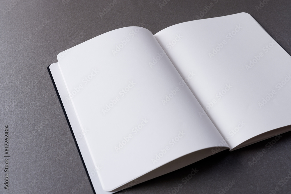 Poster close up of open book with copy space on grey background