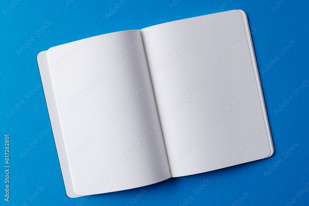 Poster close up of open book with copy space on blue background