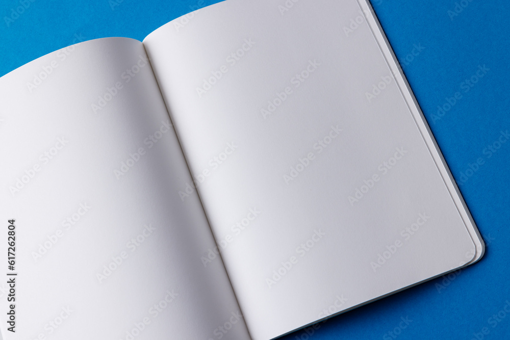 Poster close up of open book with copy space on blue background