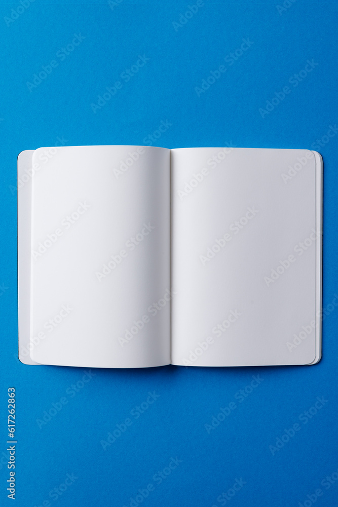 Poster close up of open book with copy space on blue background