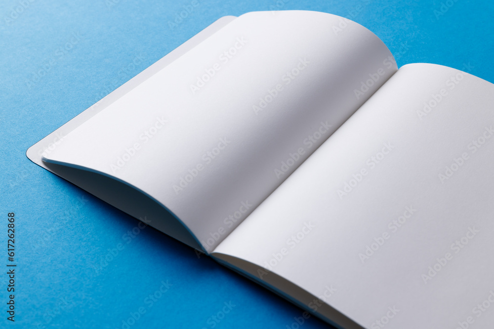 Poster close up of open book with copy space on blue background