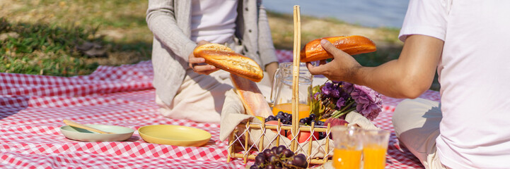 In love couple enjoying picnic time in park outdoors Picnic. happy couple relaxing together with picnic Basket