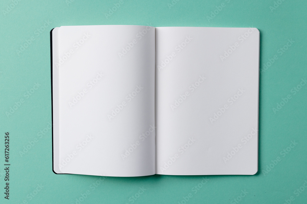 Poster close up of open book with copy space on green background