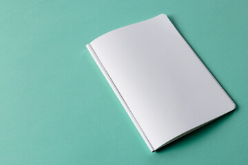 Close up of open book with copy space on green background