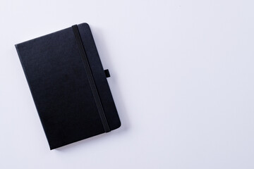 Close up of black notebook with copy space on white background