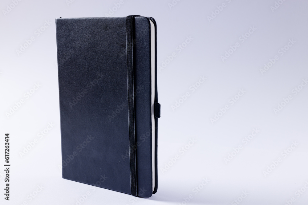 Poster close up of black notebook with copy space on white background